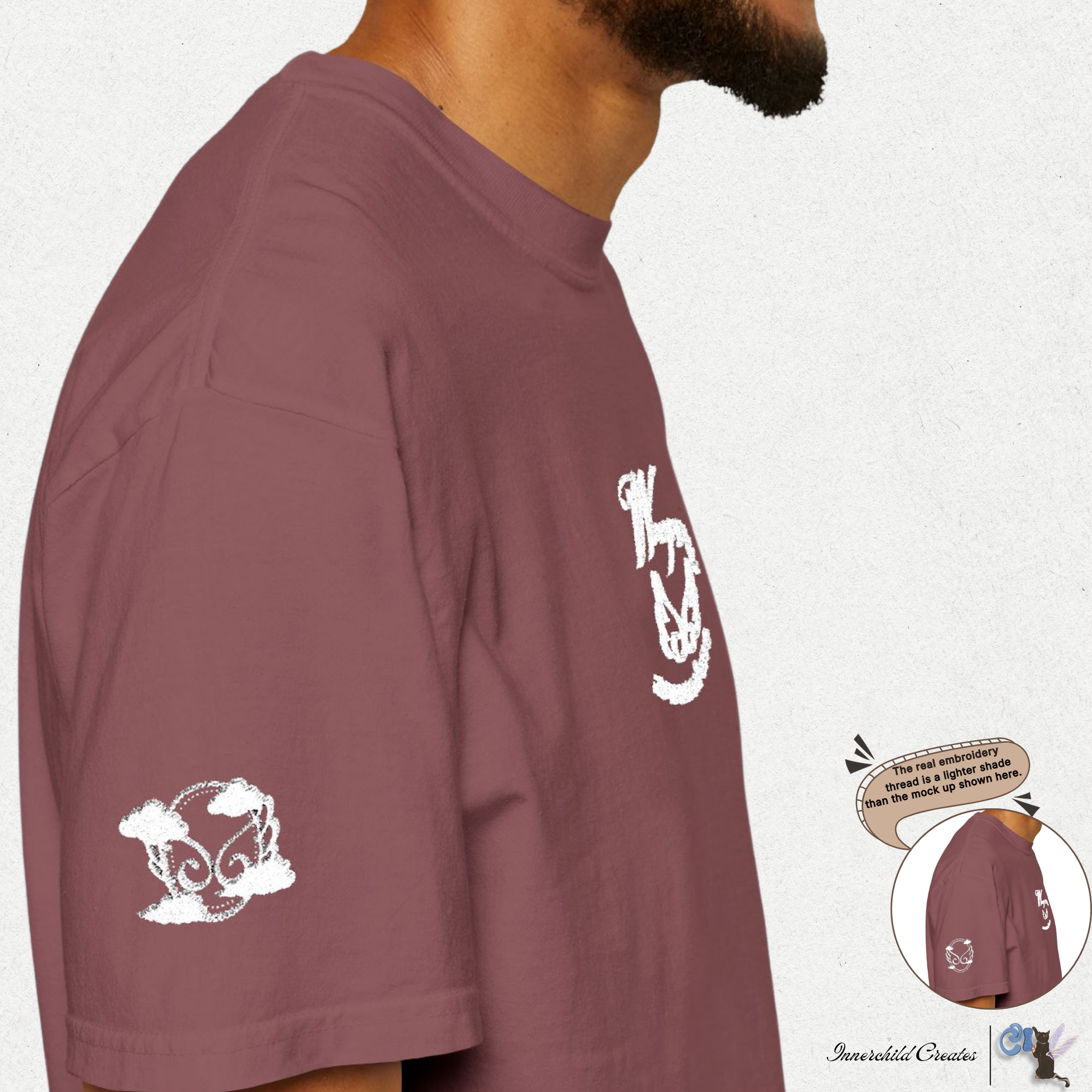Maroon t-shirt with white graphics on a white background. Brick t-shirt. White embroidery of wings and clouds. 